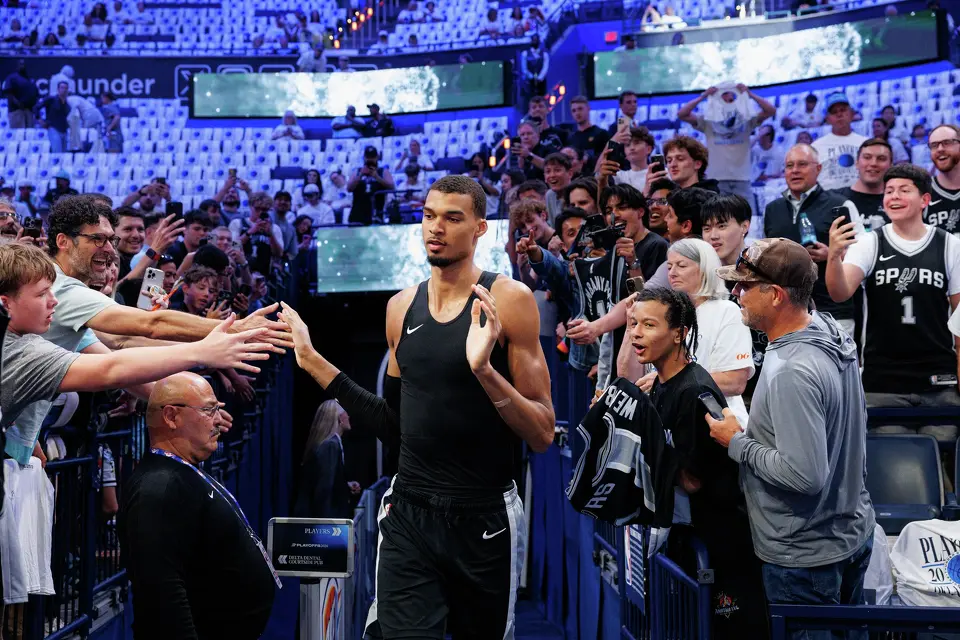 San Antonio Spurs center Victor Wembanyama slaps hands with fans as he runs onto the court to warm up before Game 5 of the Western Conference Finals against the Oklahoma City Thunder at Paycom Center in Oklahoma City, Tuesday, May 26, 2026.