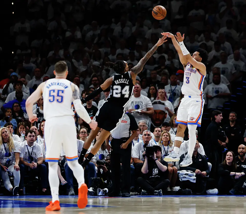 San Antonio Spurs guard Devin Vassell (24) reaches for a block attempt while Oklahoma City Thunder guard Jared McCain (3) goes up for a shot during the third quarter of Game 5 of the Western Conference Finals at Paycom Center in Oklahoma City, Tuesday, May 26, 2026.