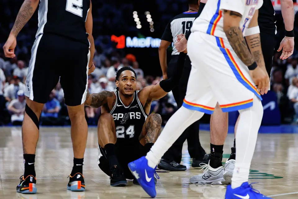 San Antonio Spurs guard Devin Vassell (24) gets up off the court with the help of his teammates during the third quarter of Game 5 of the Western Conference Finals at Paycom Center in Oklahoma City, Tuesday, May 26, 2026.
