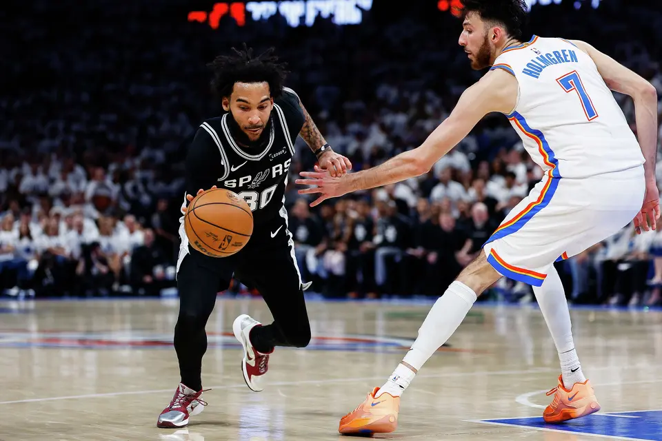 San Antonio Spurs forward Julian Champagnie (30) dribbles the ball past Oklahoma City Thunder center Chet Holmgren (7) during the third quarter of Game 5 of the Western Conference Finals at Paycom Center in Oklahoma City, Tuesday, May 26, 2026.