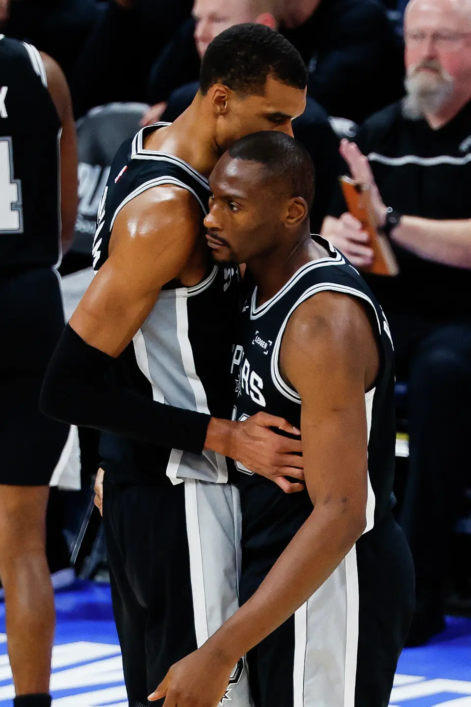 San Antonio Spurs center Victor Wembanyama (1) talk to teammate San Antonio Spurs center Bismack Biyombo (18) during the fourth quarter of Game 5 of the Western Conference Finals at Paycom Center in Oklahoma City, Tuesday, May 26, 2026. The Spurs fell to the Thunder, 127-114, who now lead the series 3-2.