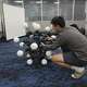 Jiaxun Liu, a Ph.D. student, works on a robot named Argus at Duke University's General Robotics Lab in Durham, N.C., Tuesday, May 26, 2026.