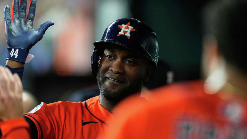 Houston Astros' Yordan Alvarez celebrates with the team after hitting a solo home run in the fourth inning of a baseball game against the Texas Rangers Wednesday, May 27, 2026, in Arlington, Texas. (AP Photo/Tony Gutierrez)