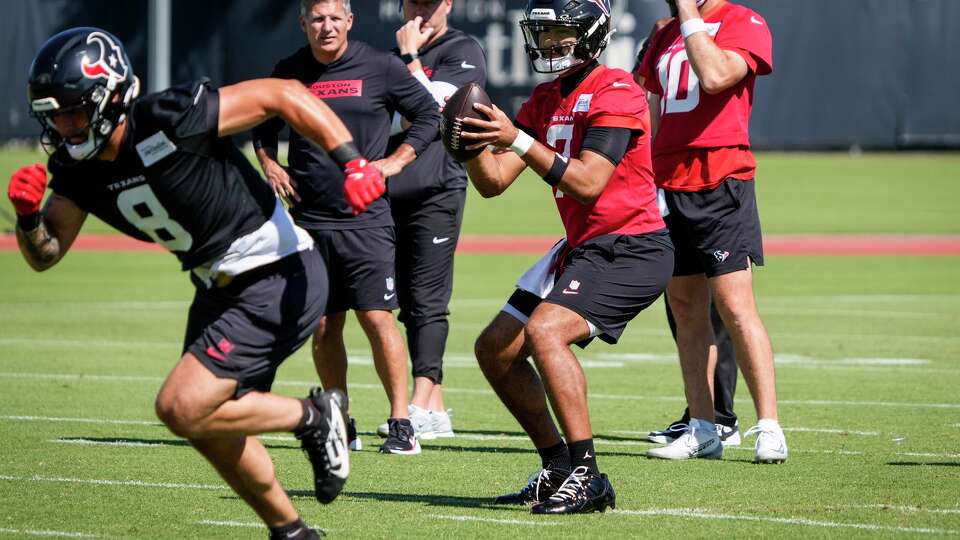 Houston Texans quarterback C.J. Stroud (7) drops back to pass as tight end Cade Stover (8) breaks out to run a route during OTAs at Houston Methodist Training Center in Houston, Thursday, May 28, 2026.