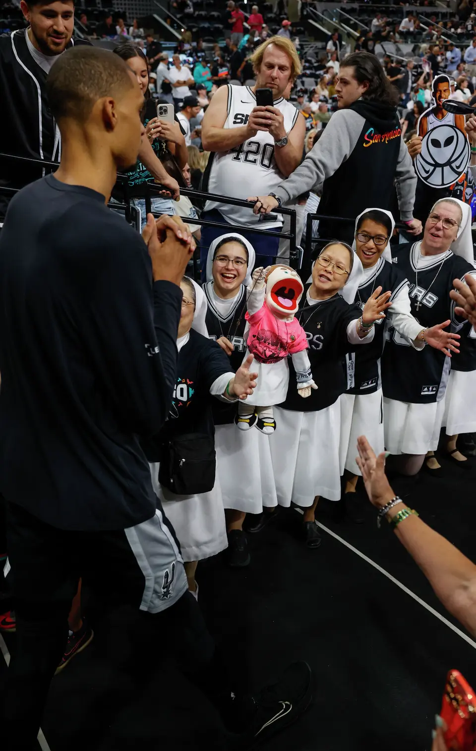 San Antonio Spurs center Victor Wembanyama (1) walks out as the Salesian Sisters of St. John Bosco cheer during Game 6 of the Western Conference Finals at Frost Bank Center in San Antonio, Thursday, May 28, 2026.