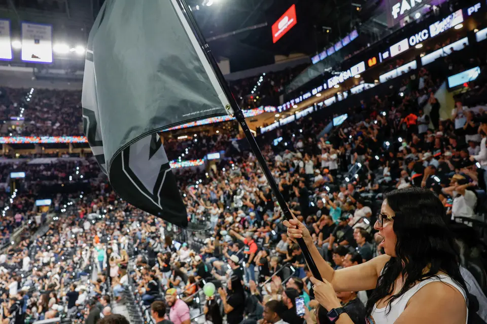 Michelle Gonzales waves a Spurs flag during Game 6 of the Western Conference Finals at Frost Bank Center in San Antonio, Thursday, May 28, 2026.
