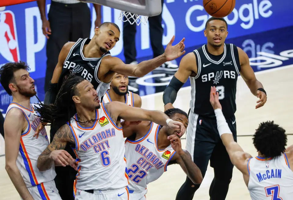 San Antonio Spurs center Victor Wembanyama (1) and San Antonio Spurs forward Keldon Johnson (3) fight for the ball during Game 6 of the Western Conference Finals at Frost Bank Center in San Antonio, Thursday, May 28, 2026.