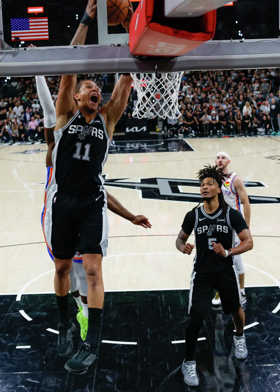 San Antonio Spurs forward Carter Bryant (11) dunks on the Oklahoma City Thunder during Game 6 of the Western Conference Finals at Frost Bank Center in San Antonio, Thursday, May 28, 2026. The Spurs won 118-91 forcing a Game 7 on Saturday.