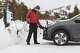 A driver charges up his vehicle in the winter. Michigan’s auto industry is evolving with EVs, AI and worker training as experts weigh what will keep the state a leader.