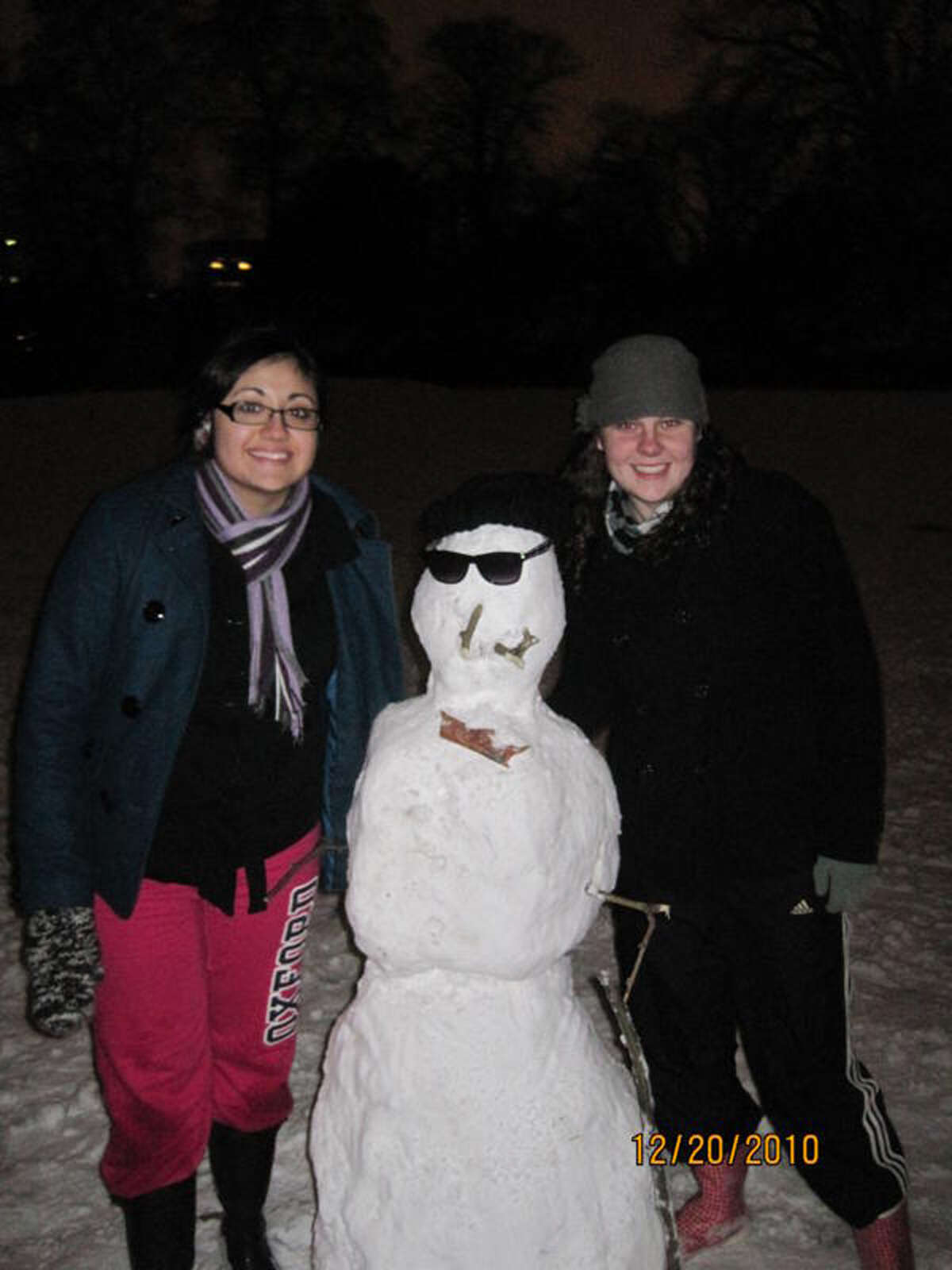 Briana Perez (left), a senior psychology student at St. Mary’s University, and Emily Scruggs, a junior English/communications arts major, pose with Heathrow the Snowman, who was named in honor of the closed airport in London.