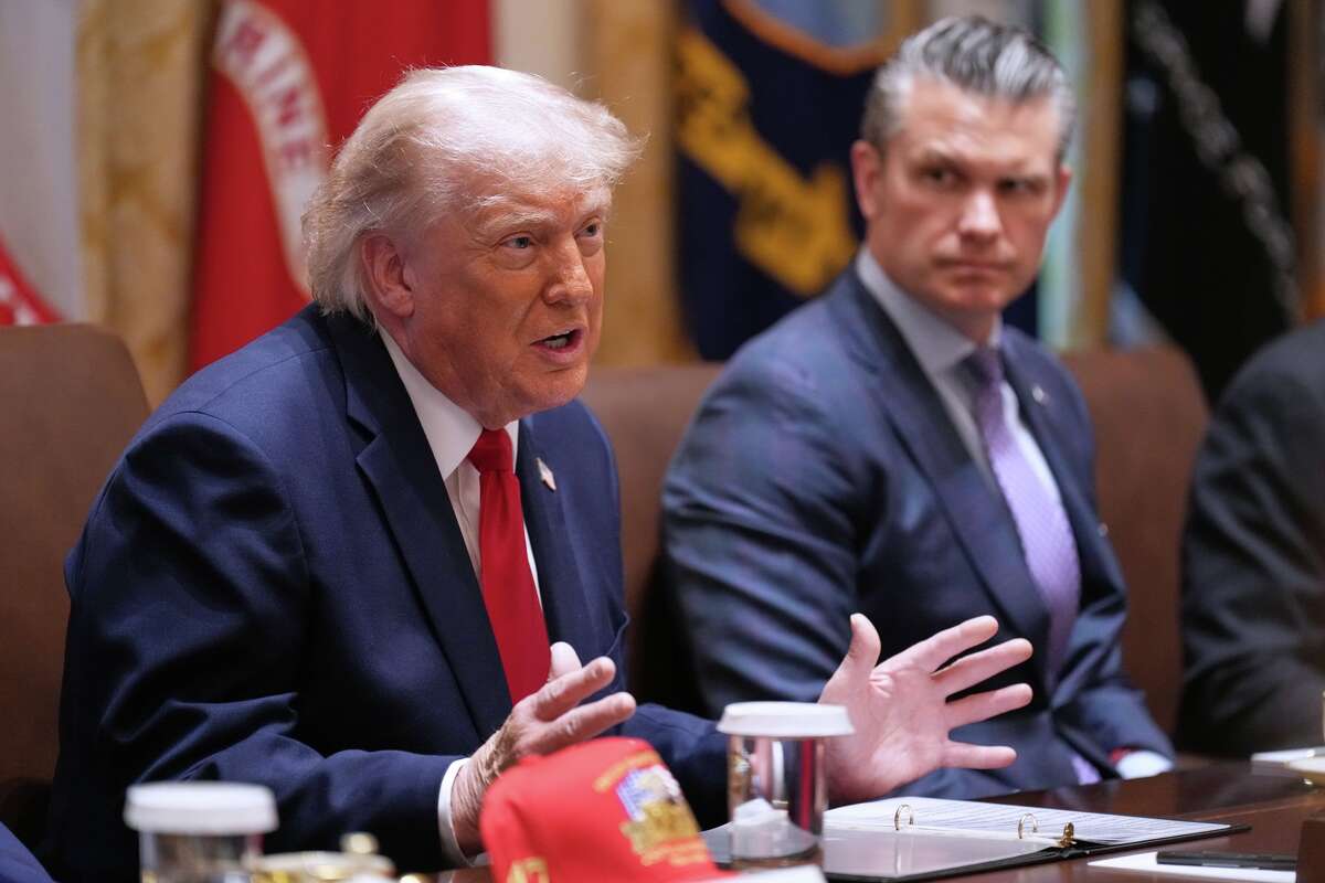 President Donald Trump speaks during a Cabinet meeting at the White House, Wednesday, May 27, 2026, in Washington, as Secretary of Defense Pete Hegseth, looks on.