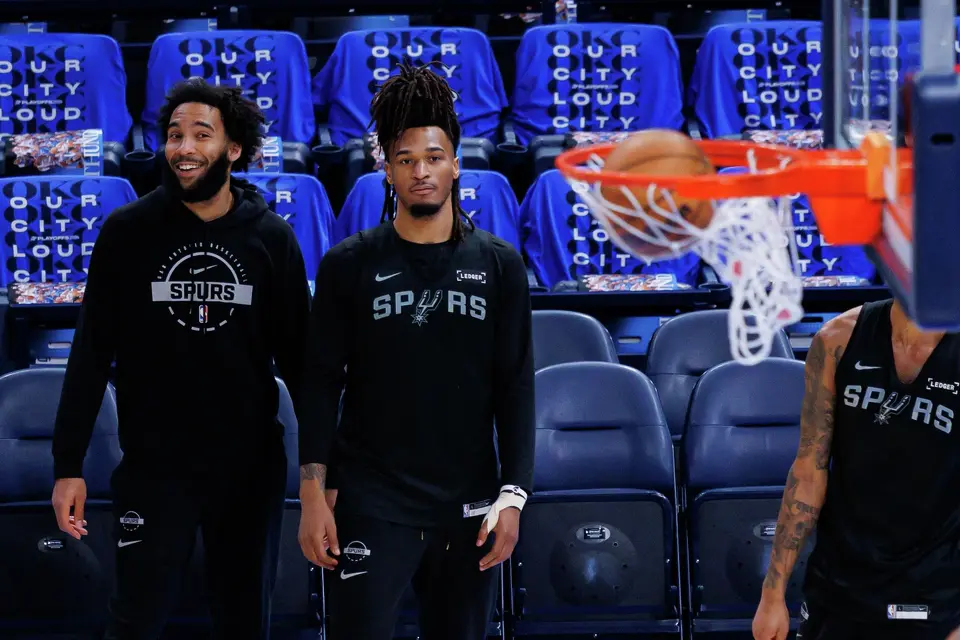 San Antonio Spurs forward Julian Champagnie, from left, and guard Stephon Castle, left, watch their teammate guard Devin Vassell (24) shoot a 3-pointer during shootaround at Paycom Center in Oklahoma City, Saturday, May 30, 2026, as they prepare for Game 7 of the Western Conference Finals against the Oklahoma City Thunder.