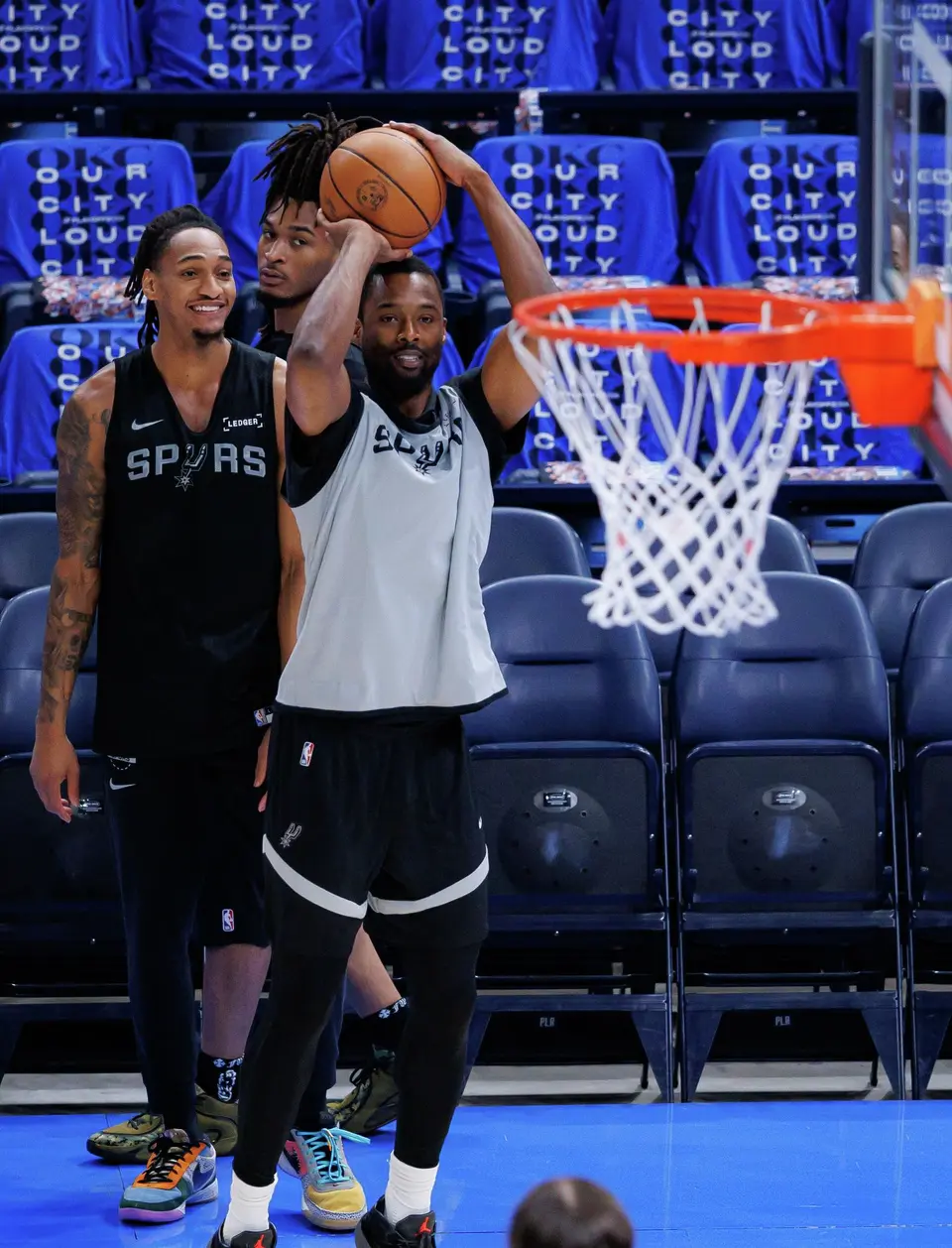 San Antonio Spurs forward Harrison Barnes (40) shoots a 3-pointer as his teammates guard Devin Vassell (24) and guard Stephon Castle (5) watch during shootaround at Paycom Center in Oklahoma City, Saturday, May 30, 2026, as they prepare for Game 7 of the Western Conference Finals against the Oklahoma City Thunder. Barnes is part of a group of teammates joining Victor Wembanyama in his home country of France this week for team bonding and offseason workouts.