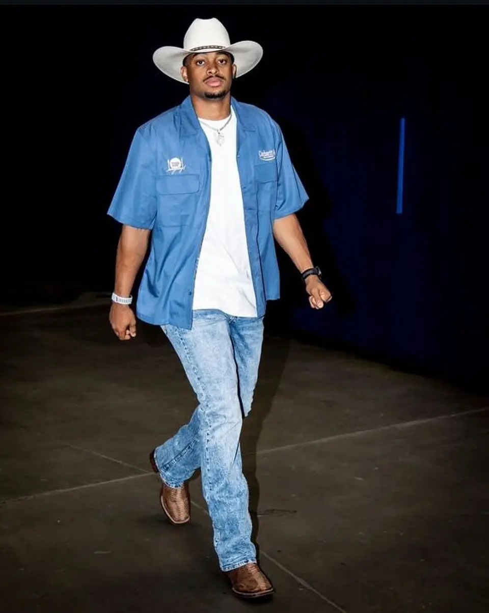 Keldon Johnson embraces Texas style with a white cowboy hat, blue work shirt and cowboy boots ahead of Game 7.