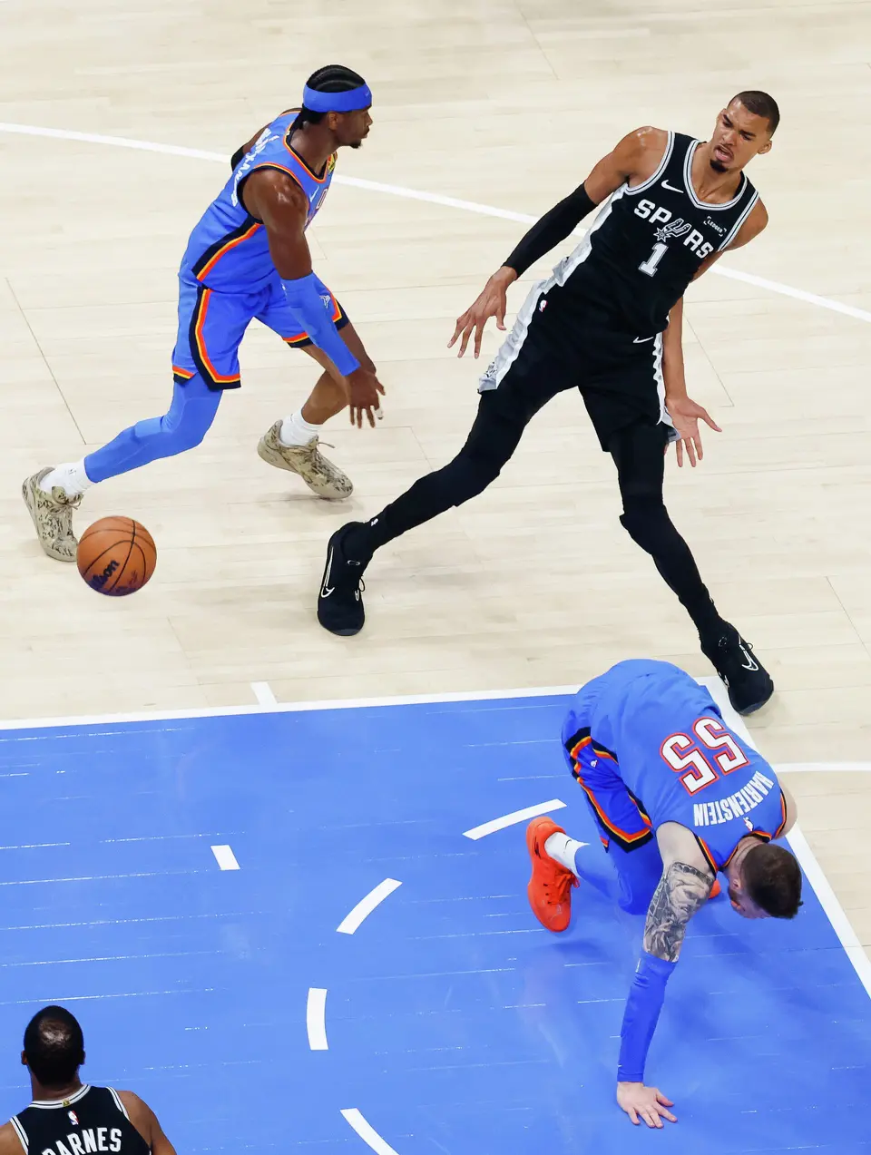 Oklahoma City Thunder guard Shai Gilgeous-Alexander (2) and center Isaiah Hartenstein (55) guard San Antonio Spurs center Victor Wembanyama (1) during Game 7 of the Western Conference finals at Paycom Center in Oklahoma City, on Saturday, May 30, 2026.