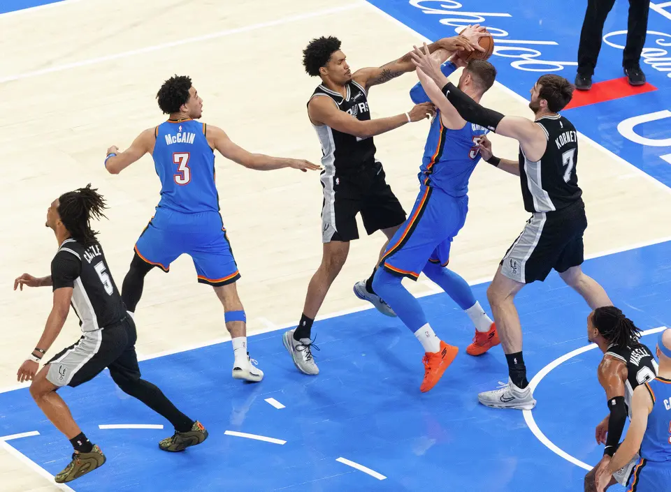 San Antonio Spurs guard Dylan Harper (2) and center Luke Kornet (7) defend Oklahoma City Thunder center Isaiah Hartenstein (55) during Game 7 of the Western Conference finals at Paycom Center in Oklahoma City, on Saturday, May 30, 2026.
