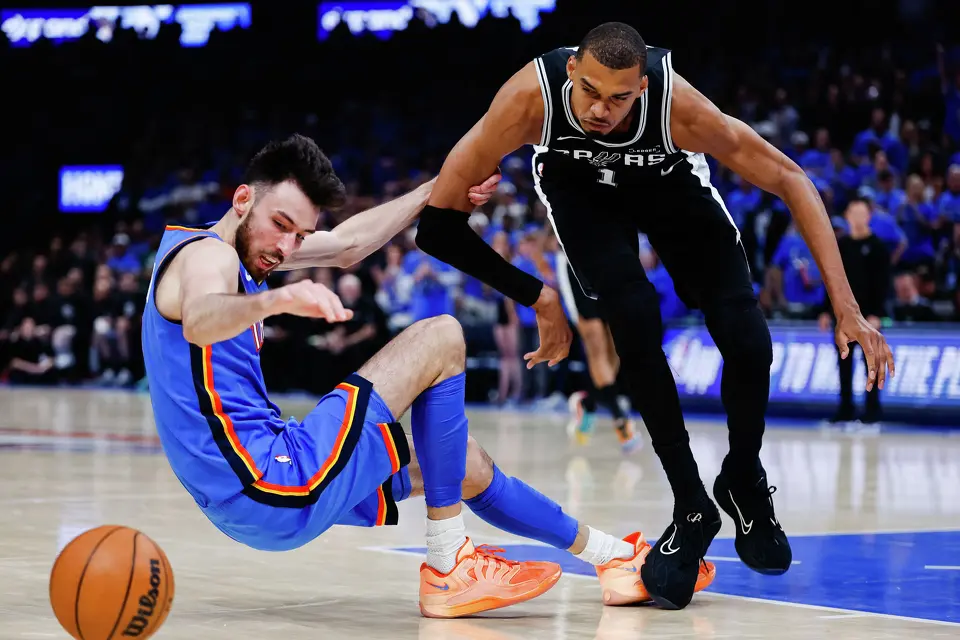 Oklahoma City Thunder center Chet Holmgren (7) grabs San Antonio Spurs center Victor Wembanyama (1) as the chase after the ball during the third quarter of Game 7 of the Western Conference Finals at Paycom Center in Oklahoma City, Saturday, May 30, 2026.