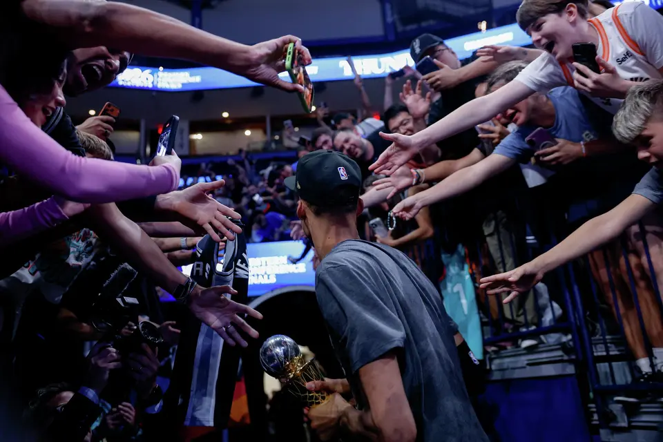 San Antonio Spurs center Victor Wembanyama lets fans touch his Earvin “Magic” Johnson Trophy after the Spurs defeated the Oklahoma City Thunder in the Western Conference finals at Paycom Center on Saturday, May 30, 2026, in Oklahoma City. Wembanyama was named Western Conference finals MVP and advanced San Antonio to the NBA Finals against the New York Knicks.