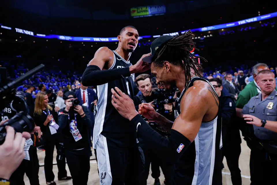 San Antonio Spurs center Victor Wembanyama puts a Western Conference Finals champion hat on San Antonio Spurs guard Devin Vassell’s head as they celebrate their victory over the Oklahoma City Thunder in Game 7 at Paycom Center in Oklahoma City, Saturday, May 30, 2026. The Spurs defeated the Thunder 111-103 to advance to the NBA Finals against the New York Knicks.