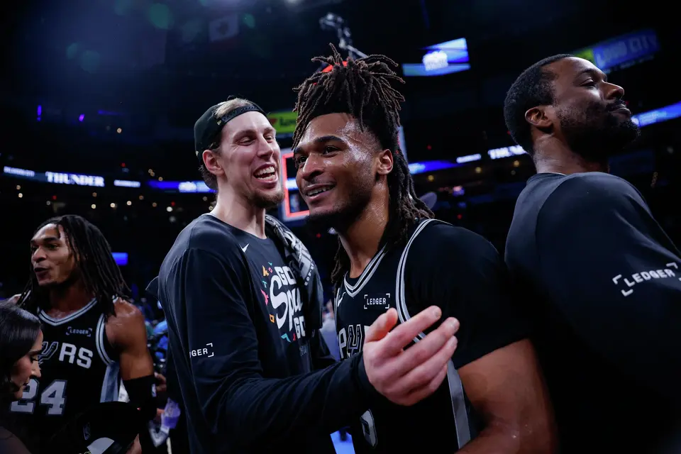 San Antonio Spurs guard Devin Vassell, from left, forward Kelly Olynyk, guard Stephon Castle and forward Harrison Barnes celebrate their victory over the Oklahoma City Thunder in the Western Conference Finals at Paycom Center in Oklahoma City, Saturday, May 30, 2026. The Spurs defeated the Thunder 111-103 in Game 7 to advance to the NBA Finals against the New York Knicks.
