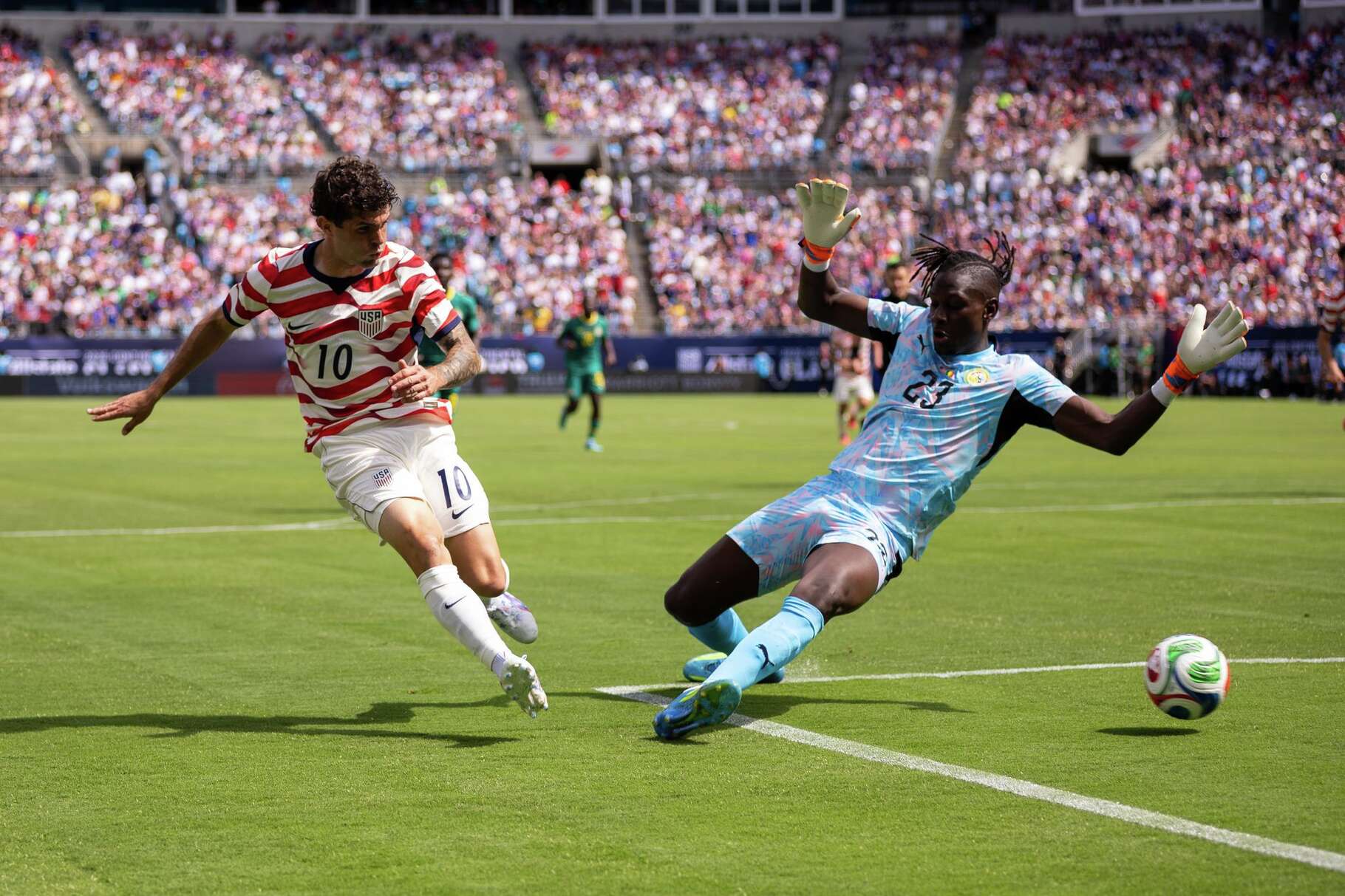 United States forward Christian Pulisic (10) shoots past Senegal forward Cherif Ndiaye (23) during the first half of an international friendly soccer match Sunday, May 31, 2026, in Charlotte, N.C.