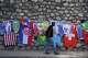A pedestrian walks past flags and soccer jerseys for sale in a street in Port-au-Prince, Haiti, Wednesday, May 27, 2026.