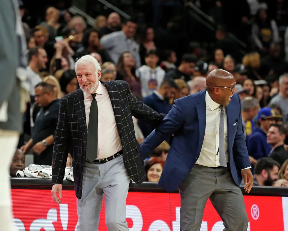 Head coach of the San Antonio Spurs Gregg Popovich ran over to the Golden State Warriors bench at the end of regulation and is greeted by assistant coach Mike Brown, but the game was not over on Tuesday, December 31, 2019. Spur 117-Warriors 113 in OT.