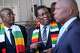 FILE - Zimbabwean President Emmerson Mnangagwa, center, stands next to his chief election agent and Justice Minister Ziyambi Ziyambi, left, outside the nomination court in Harare, Zimbabwe, June 21, 2023.