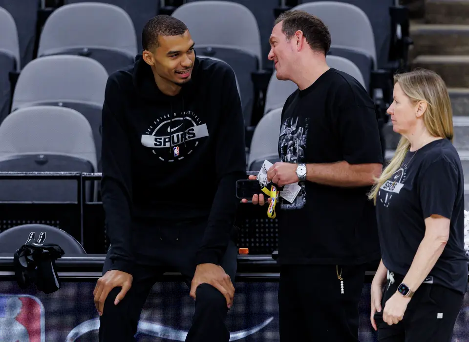 San Antonio Spurs center Victor Wembanyama, left, talks to Peter J. Holt, the managing partner and chairman of Spurs Sports & Entertainment, during practice at Frost Bank Center in San Antonio, Tuesday, June 2, 2026, ahead of the NBA Finals series against the New York Knicks.