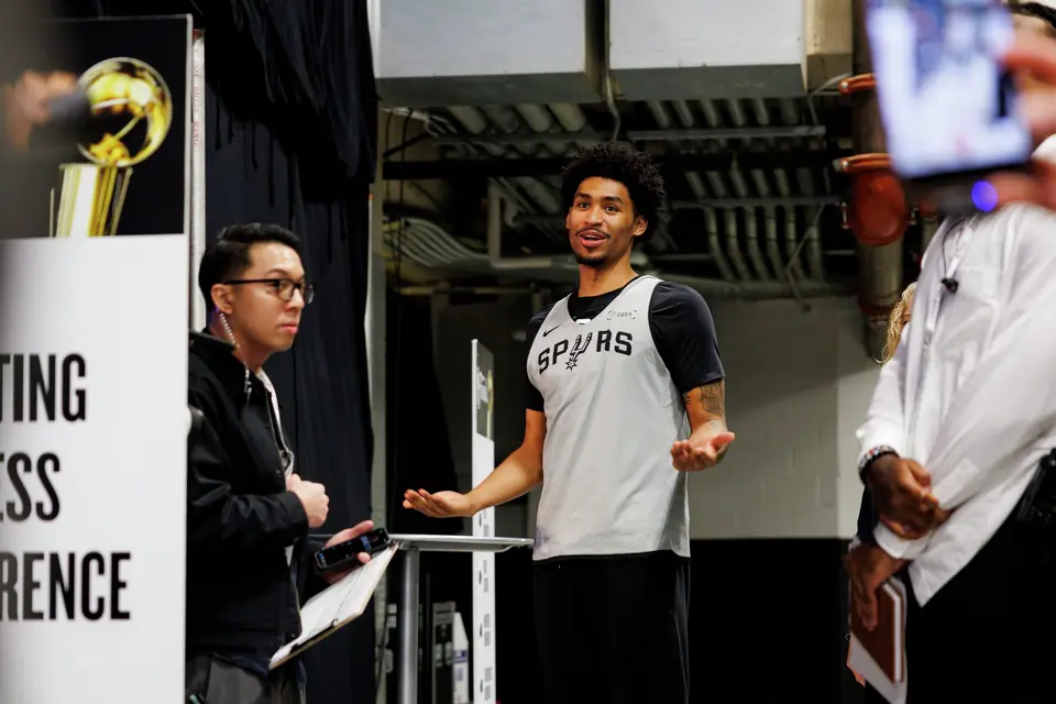 San Antonio Spurs guard Dylan Harper, center, jokes with his teammate guard De'Aaron Fox, not pictured, as he walks into a news conference at Frost Bank Center in San Antonio, Tuesday, June 2, 2026, ahead of the NBA Finals series between the Spurs and the New York Knicks.