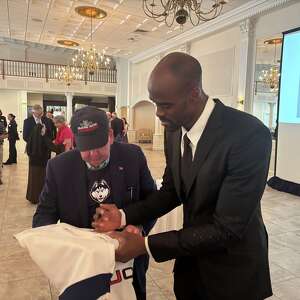 UConn men's basketball great Emeka Okafor honored with his wife at Franciscan banquet