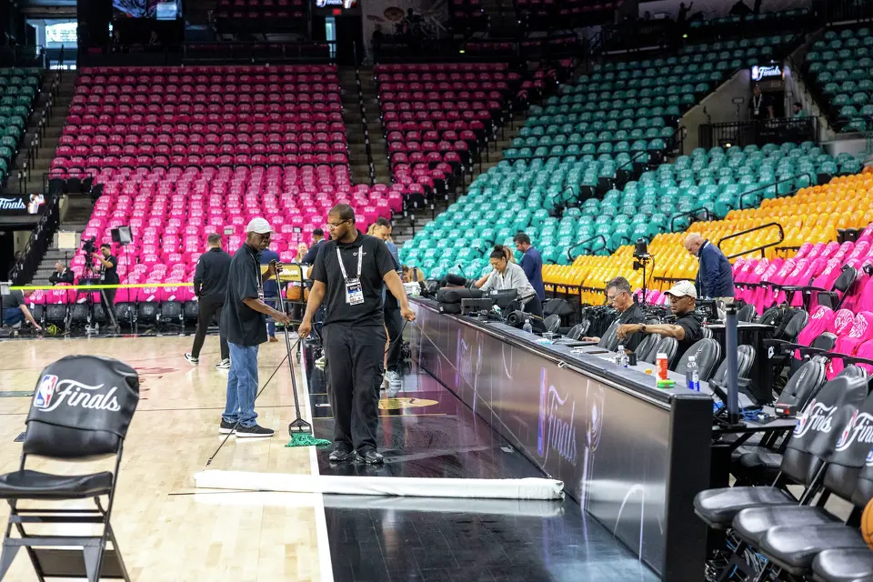 Staff workers mop the court before Game 1 of the NBA Finals at Frost Bank Center in San Antonio, Wednesday, June 3, 2026.