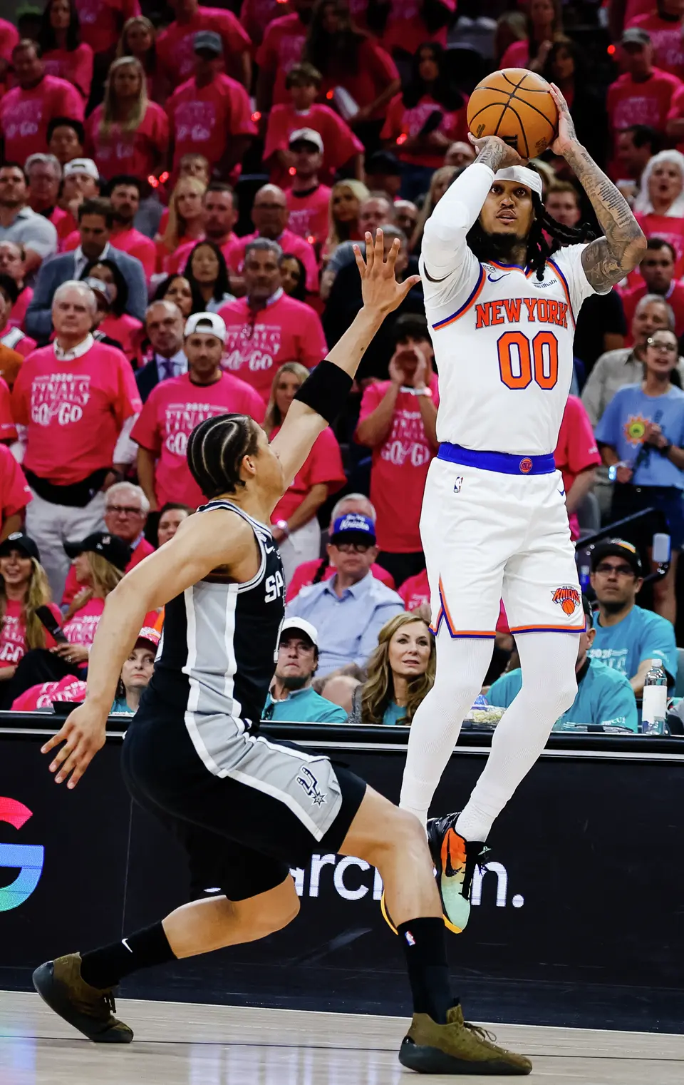 New York Knicks guard Jordan Clarkson (00) jumps up for a shot while defended by San Antonio Spurs forward Carter Bryant (11) during Game 1 of the NBA Finals at Frost Bank Center in San Antonio, on Wednesday, June 3, 2026.