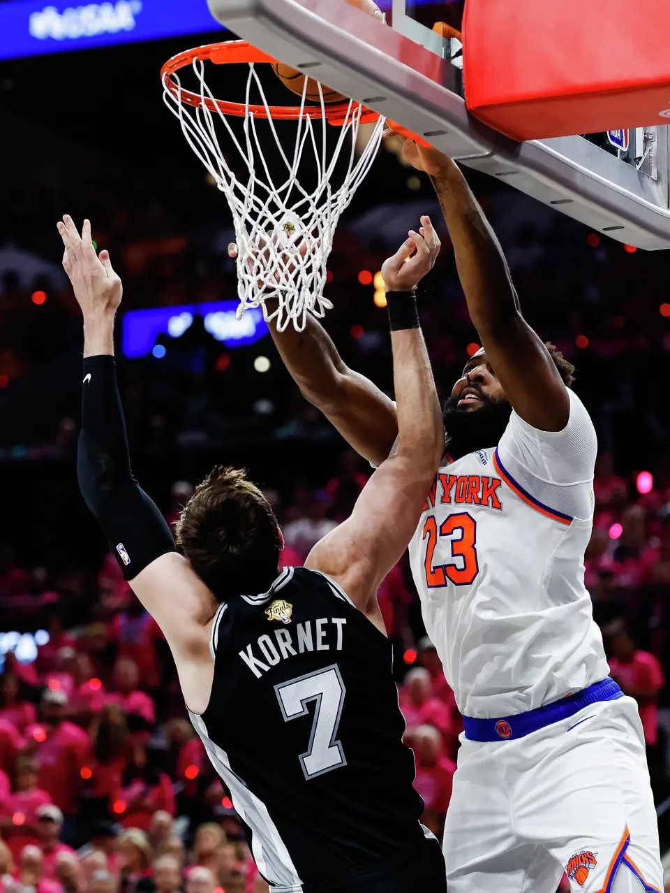 San Antonio Spurs center Luke Kornet (7) goes up to the basket as New York Knicks center Karl-Anthony Towns (32) makes a shot during Game 1 of the NBA Finals at Frost Bank Center in San Antonio, on Wednesday, June 3, 2026.