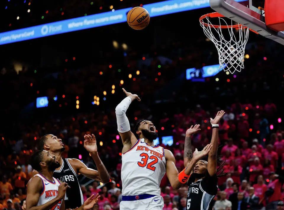 New York Knicks center Karl-Anthony Towns (32) goes up to the basket while guarded by San Antonio Spurs center Victor Wembanyama (1) and San Antonio Spurs guard Stephon Castle (5) during Game 1 of the NBA Finals at Frost Bank Center in San Antonio, on Wednesday, June 3, 2026.