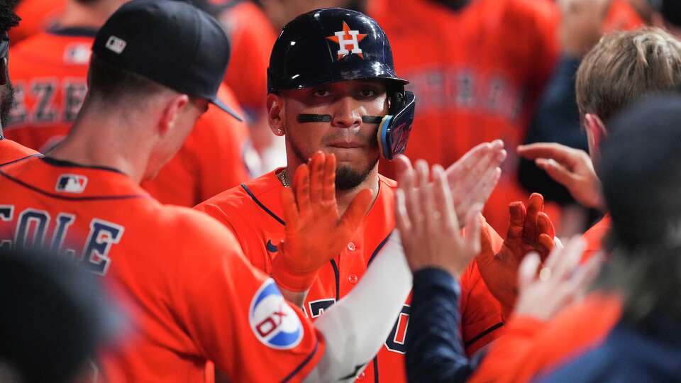 Houston Astros Isaac Paredes (15) gets high-fives in the dugout after hitting a 2-run home run during the eighth inning of an MLB baseball game in Houston, Wednesday, June 3, 2026.
