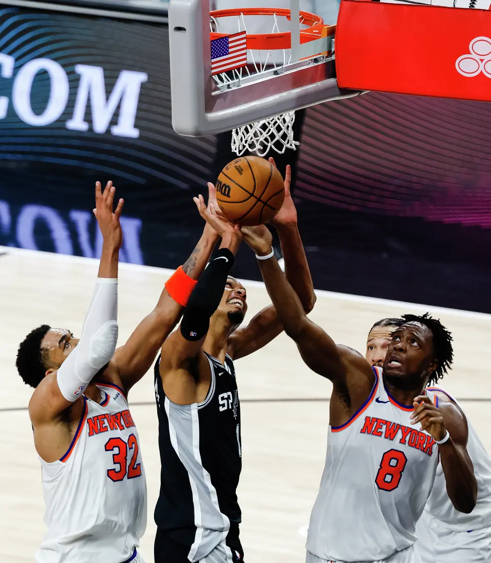 San Antonio Spurs center Victor Wembanyama (1) goes up two the basket while guarded by New York Knicks center Karl-Anthony Towns (32) and forward Og Anunoby (8) during Game 1 of the NBA Finals at Frost Bank Center in San Antonio, on Wednesday, June 3, 2026.