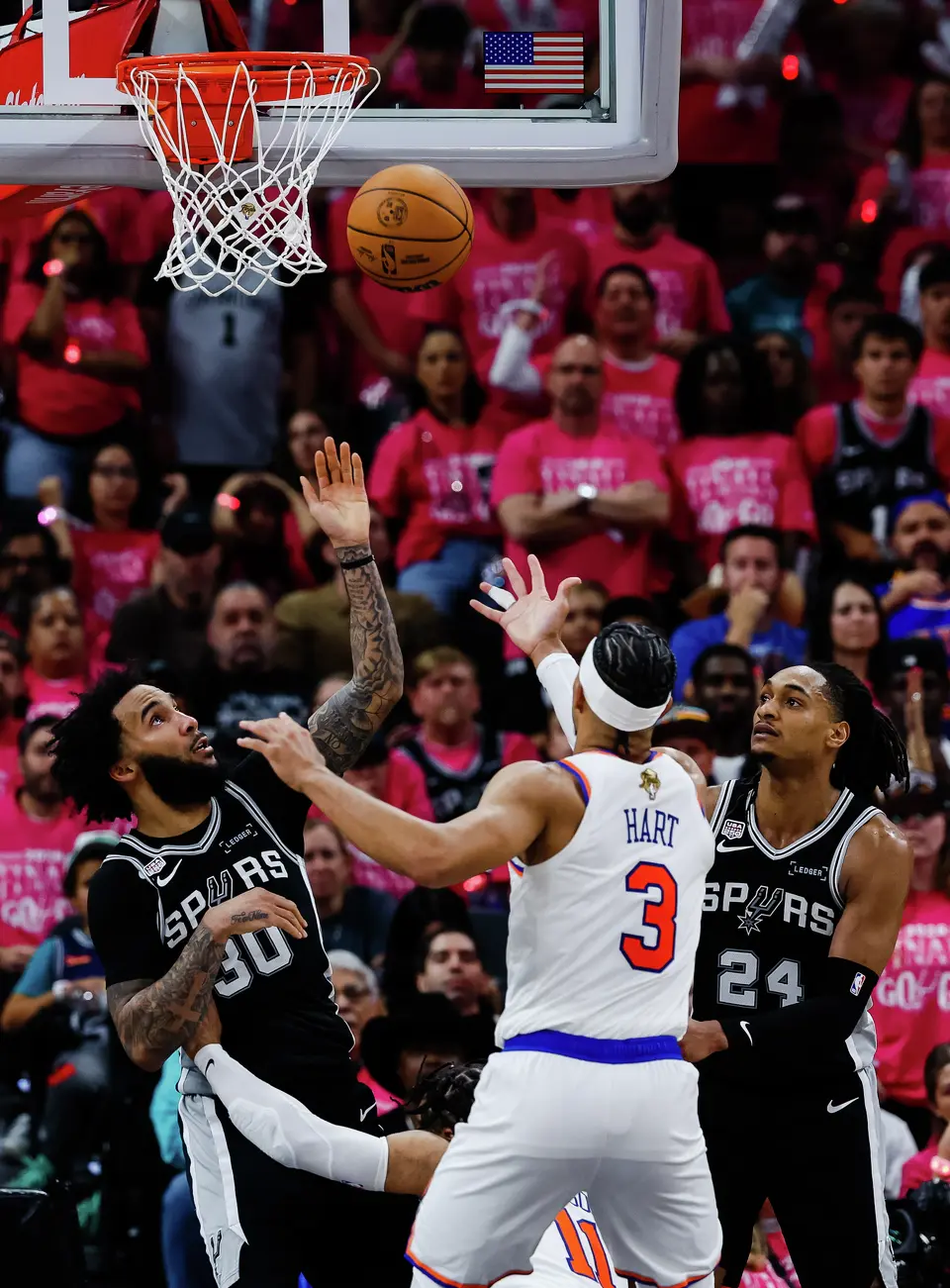 San Antonio Spurs forward Julian Champagnie (30) and New York Knicks guard Josh Hart (3) reach for the ball during Game 1 of the NBA Finals at Frost Bank Center in San Antonio, on Wednesday, June 3, 2026.