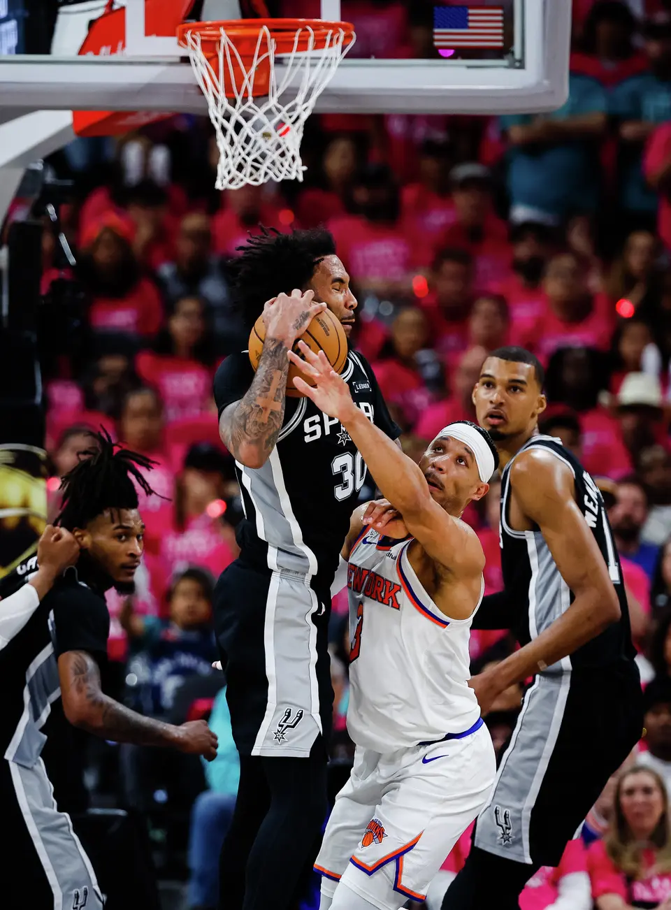 San Antonio Spurs forward Julian Champagnie (30) tries to hold onto the ball as New York Knicks guard Josh Hart (3) reaches for the ball during Game 1 of the NBA Finals at Frost Bank Center in San Antonio, on Wednesday, June 3, 2026.