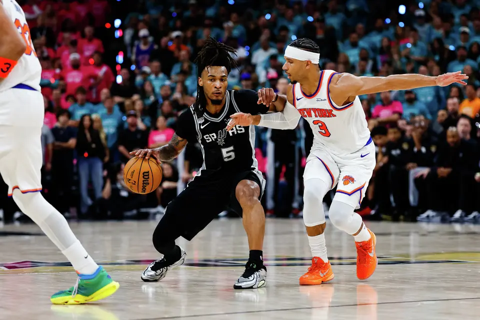 San Antonio Spurs guard Stephon Castle (5) dribbles around New York Knicks guard Josh Hart (3) during Game 1 of the NBA Finals at Frost Bank Center in San Antonio, on Wednesday, June 3, 2026.