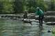 Hannah Ray J Childs, right, throws a toy for her dog as her husband Marty Colbert watches at a whitewater park she helped create on the Maquoketa River, Thursday, May 7, 2026, in Manchester, Iowa.