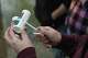 A Drake University student holds a phosphate test strip after sampling water from a stream Wednesday, May 6, 2026, in Des Moines, Iowa.