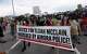 FILE - Demonstrators carry a banner while marching down Interstate 225 during a rally and march over the death of Elijah McClain, June 27, 2020, in Aurora, Colo. A trial for two of the officers charged for McClain's death is set to begin Friday, Sept. 15, 2023 with jury selection.