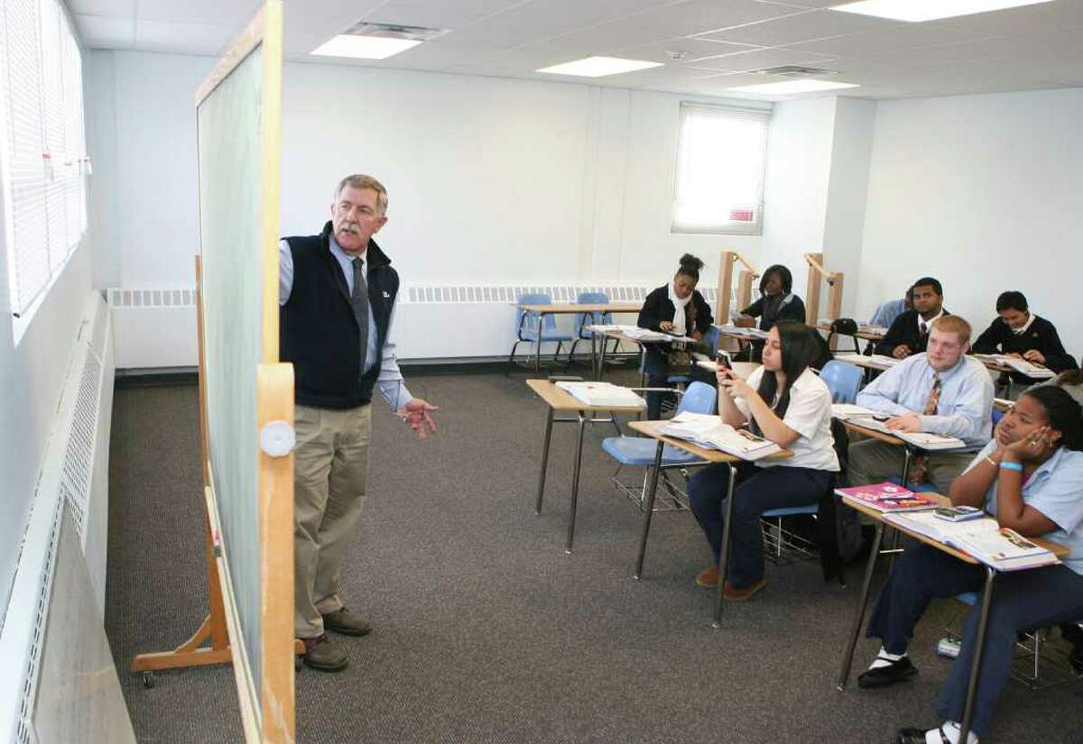 Assistant principal Phil Broadhurst teaches honors algebra 2 in a newly acquired and renovated Kolbe High School building on Monday, December 20, 2010.