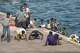 FILE - Migrants react as they arrive at the port in La Restinga on the Canary island of El Hierro, Spain, on, Aug. 19, 2024.