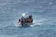 FILE - Migrants crowd a wooden boat as they sail to the port in La Restinga on the Canary island of El Hierro, Spain, Sunday, Aug. 18, 2024.