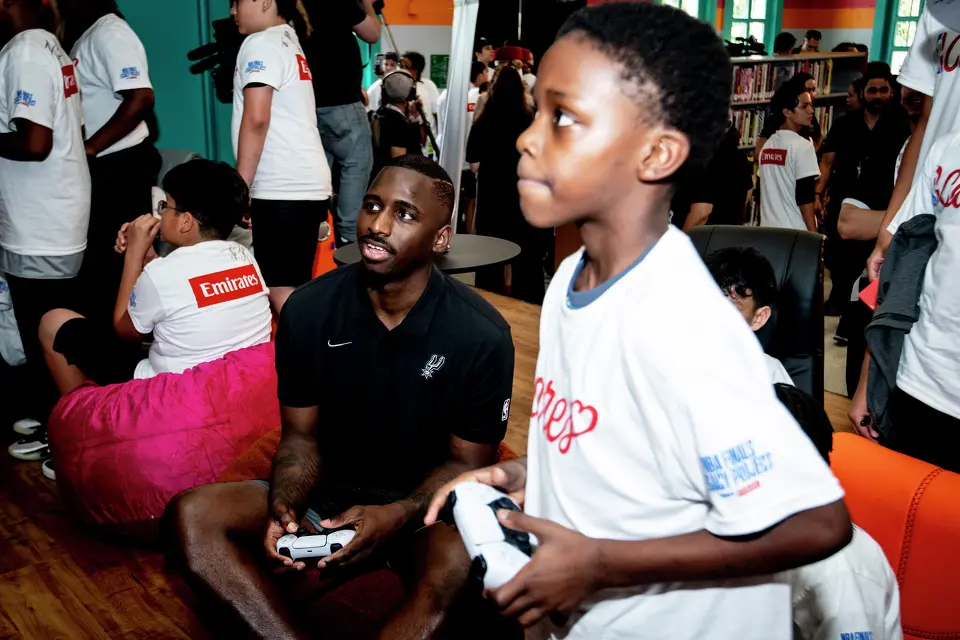 San Antonio Spurs player David Jones Garcia plays video games with children at the Denver Heights Community Center on Thursday.