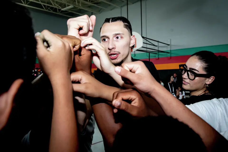 San Antonio Spurs player Lindy Waters III leads a huddle during the Legacy Project NBA Cares event at the Denver Heights Community Center on Thursday.