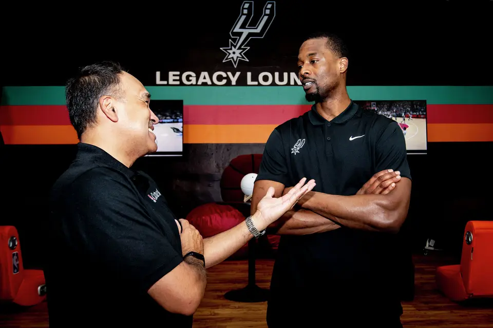 San Antonio Spurs player Harrison Barnes talks to NBA Deputy Commissioner Mark Tatum during the Legacy Project NBA Cares event at the Denver Heights Community Center on Thursday.