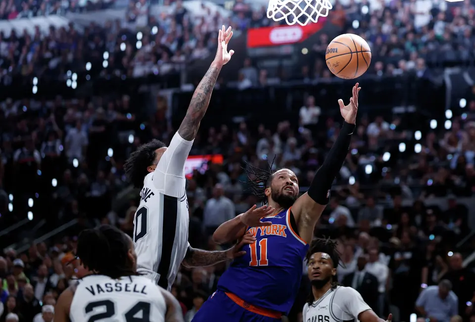 New York Knicks guard Jalen Brunson (11) goes for the layup past San Antonio Spurs forward Julian Champagnie (30) during the first quarter of Game 2 of the NBA Championship at Frost Bank Center in San Antonio on Friday, June 5, 2026.